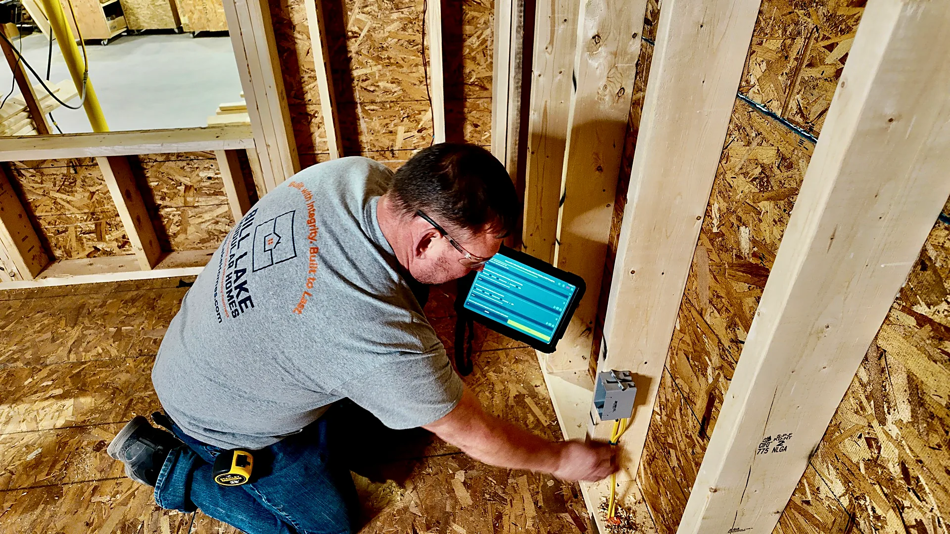 An operator working from a tablet inside a framed module