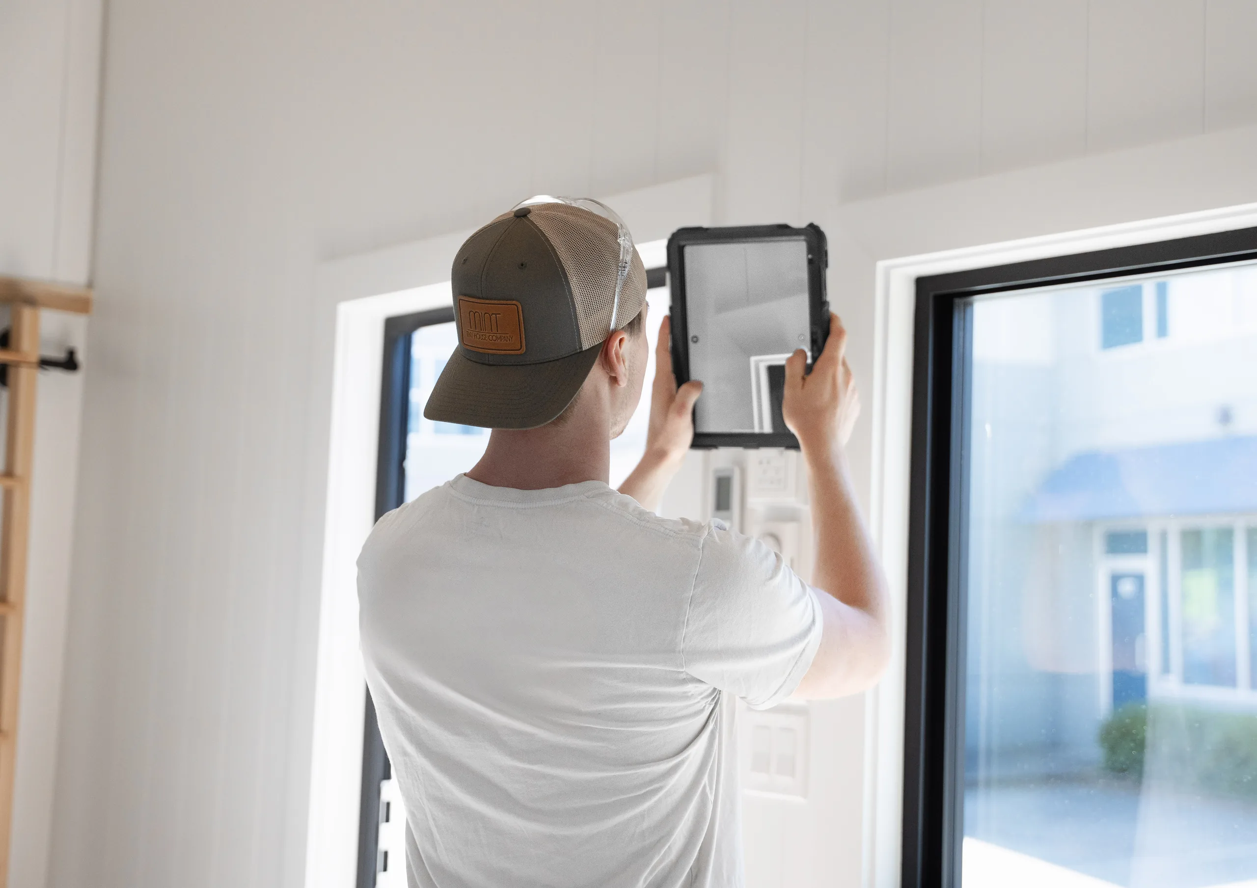A finished module interior in daylight, with a check being run from a rugged tablet