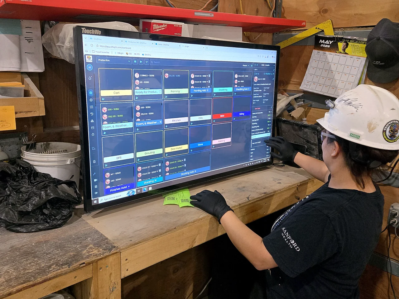 A Fullerton operator updating the Offsight production board on a shop-floor touchscreen