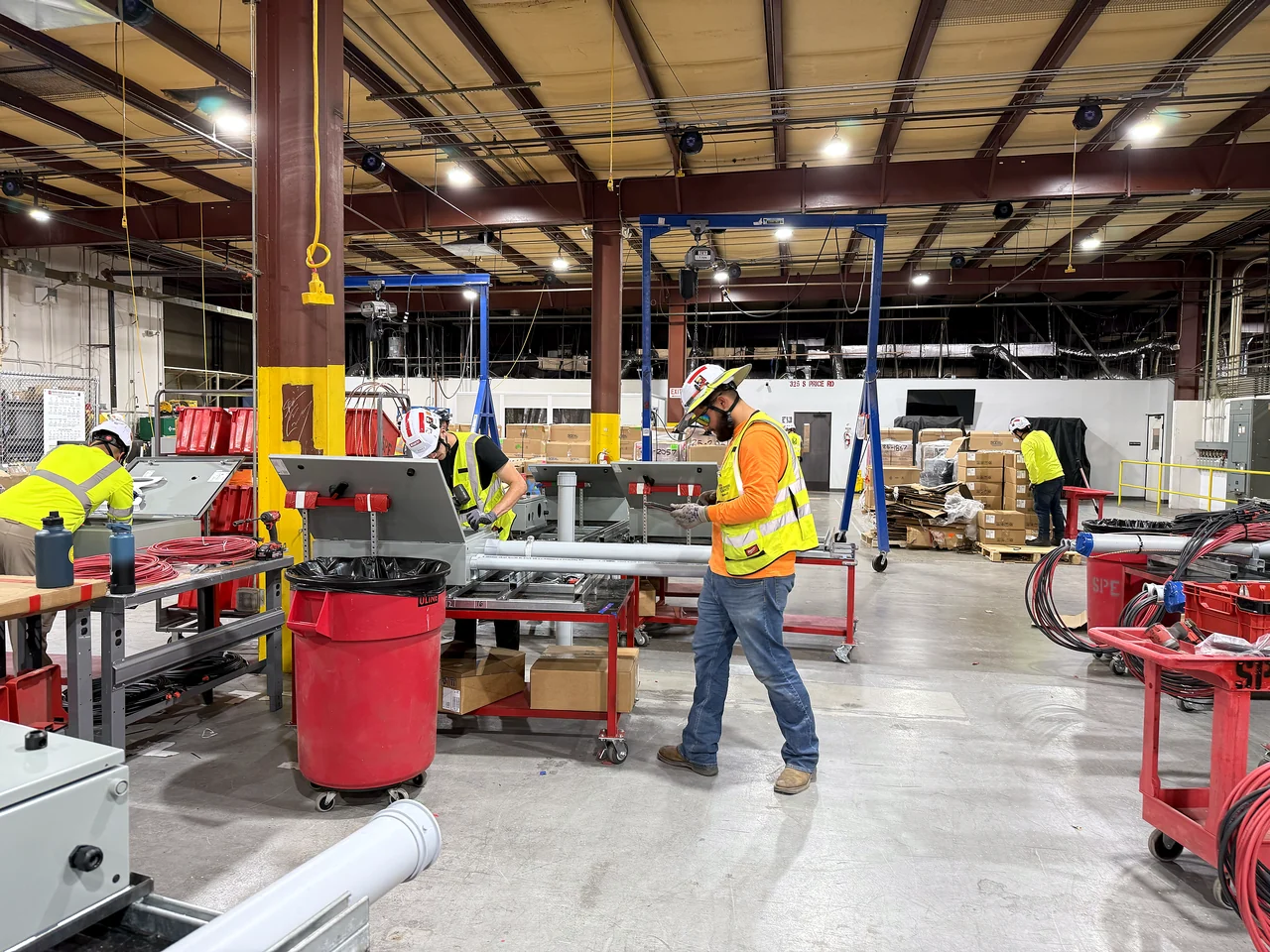 Crews working under an overhead crane on the McCarthy prefabrication floor