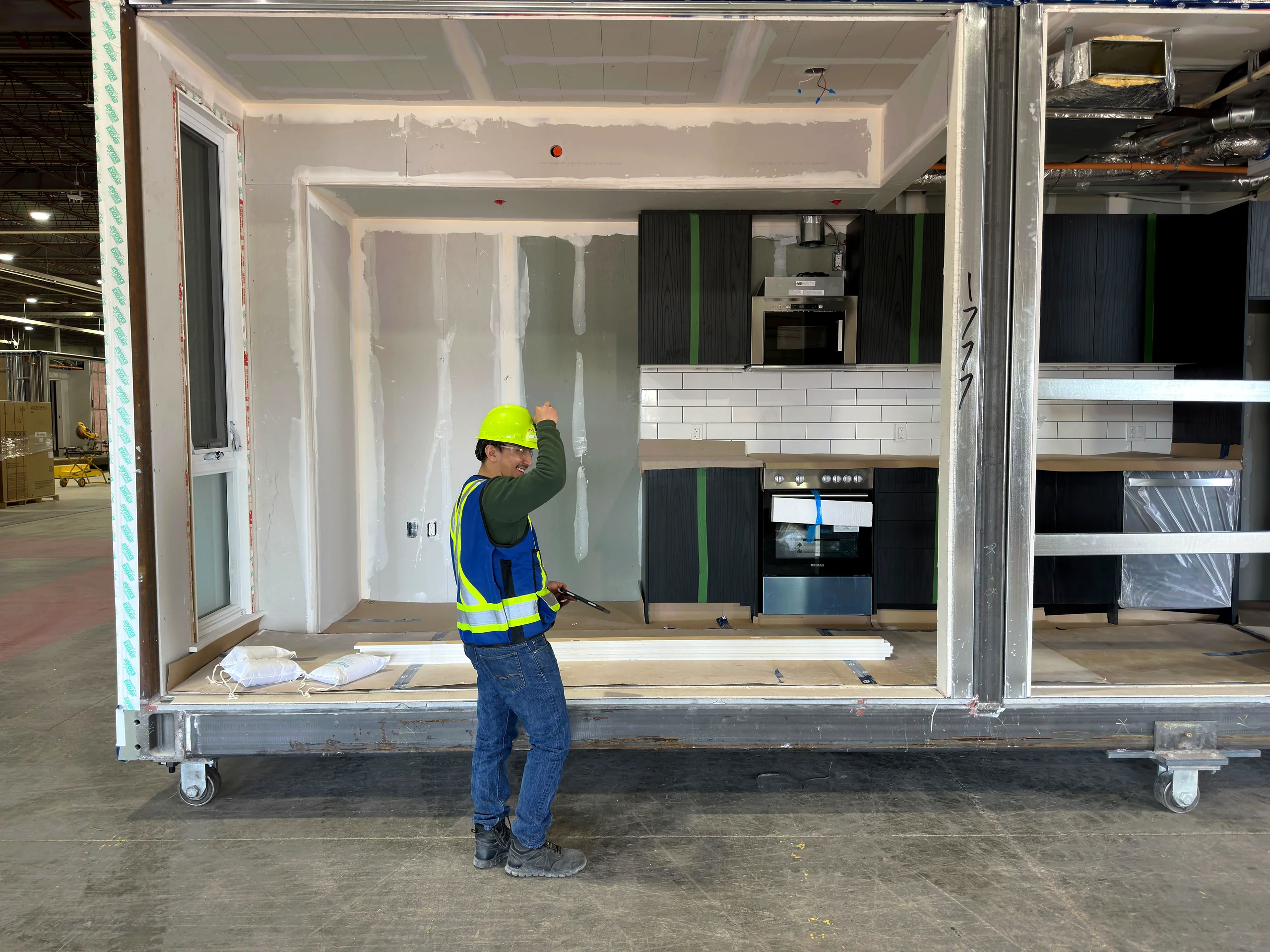 A finished kitchen inside a modular unit on the factory floor