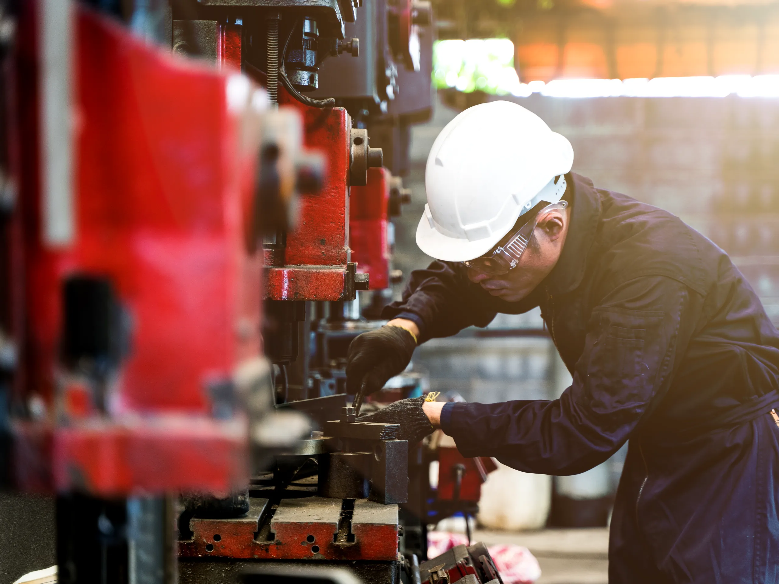 A maintenance technician working on a production machine