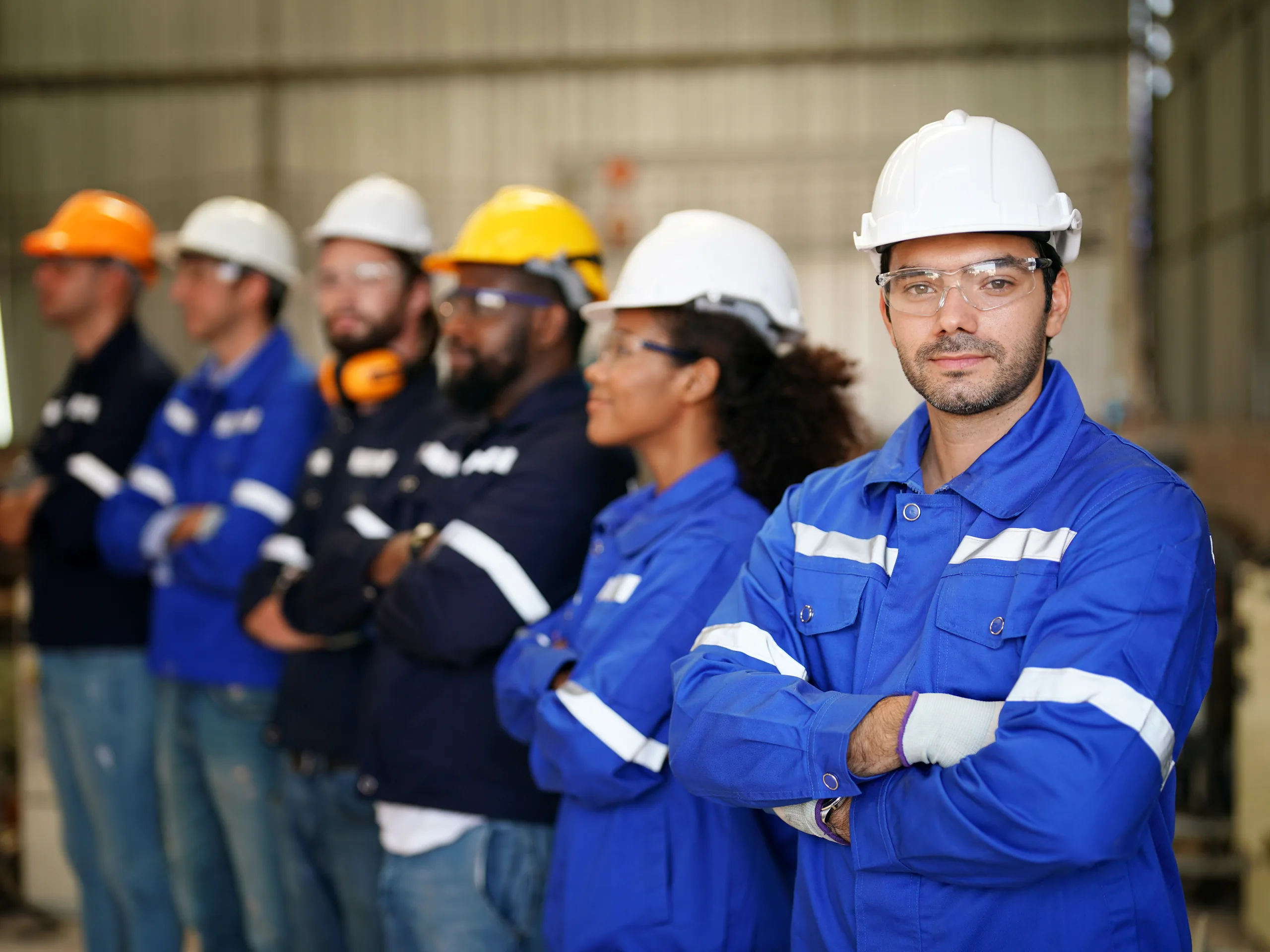 A production leader standing with their crew on the factory floor