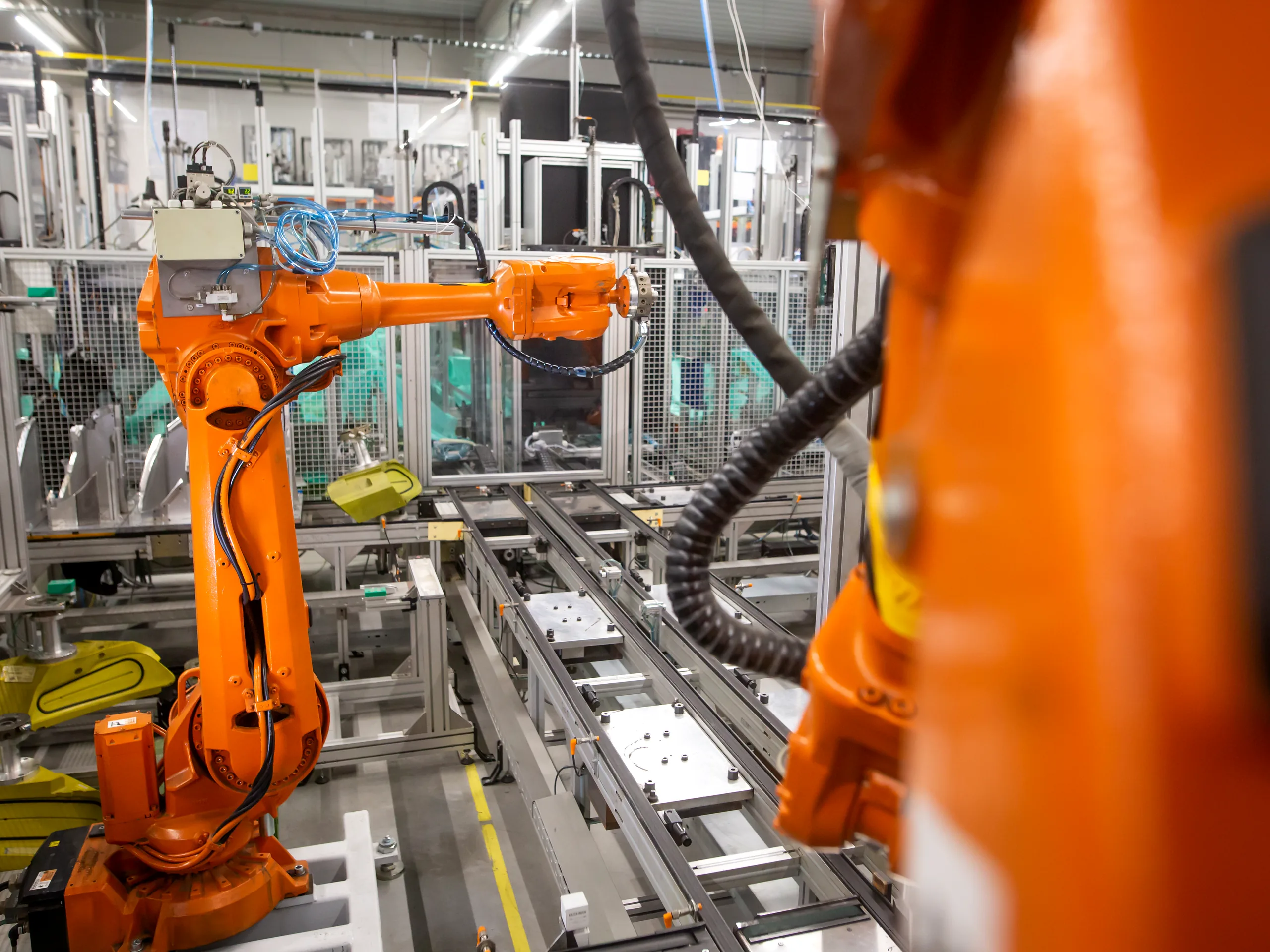 Robotic arms assembling on a live production line
