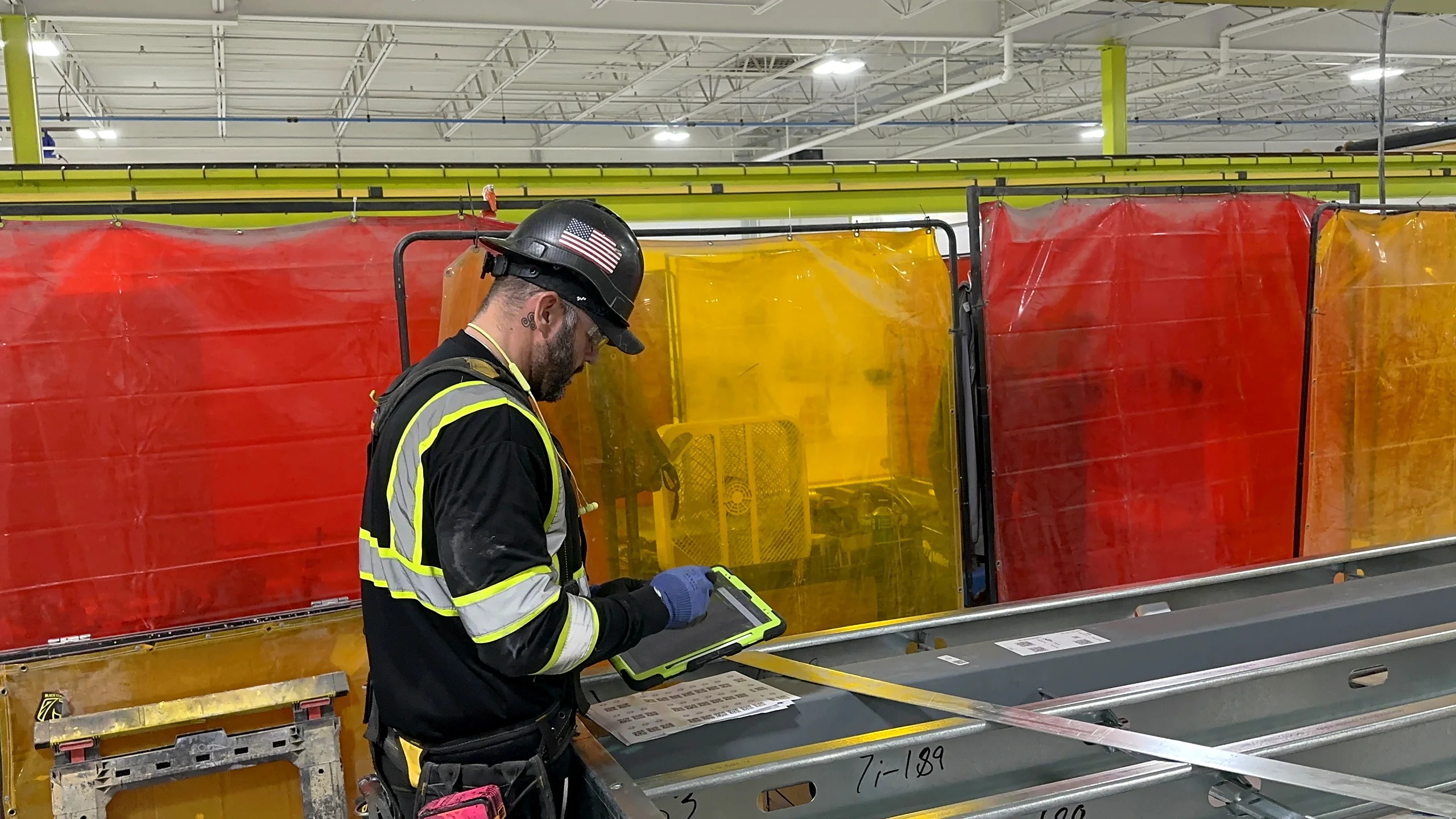 Light-gauge steel wall frames moving down a prefabrication line