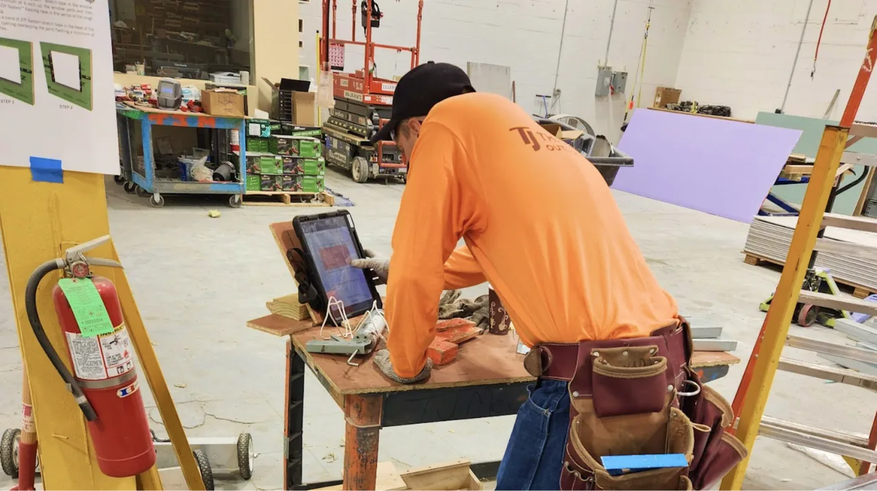 Operators working on drywall panel assemblies in the prefab shop